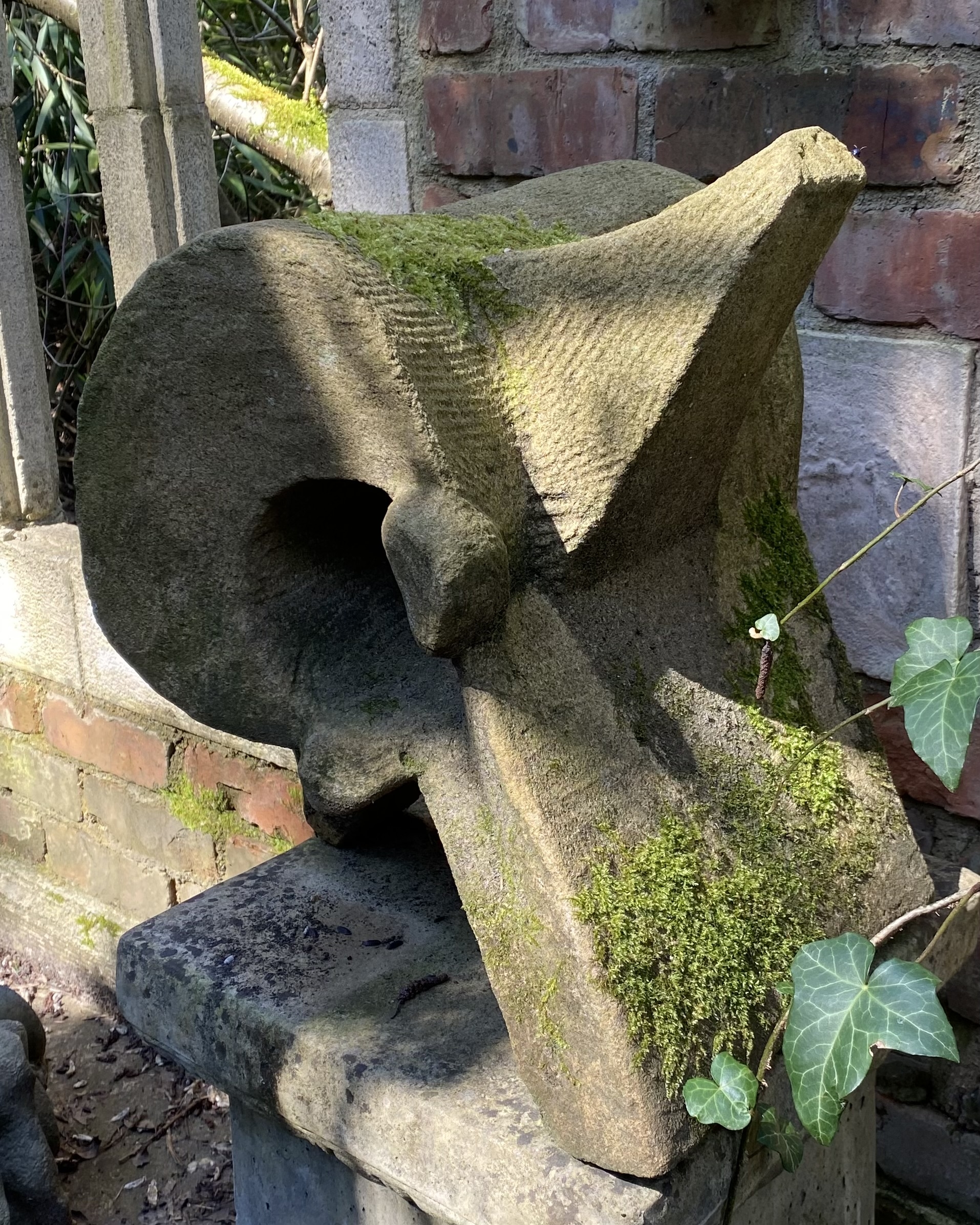 A expressionism stone sculpture of a piece of bone vertebrae.