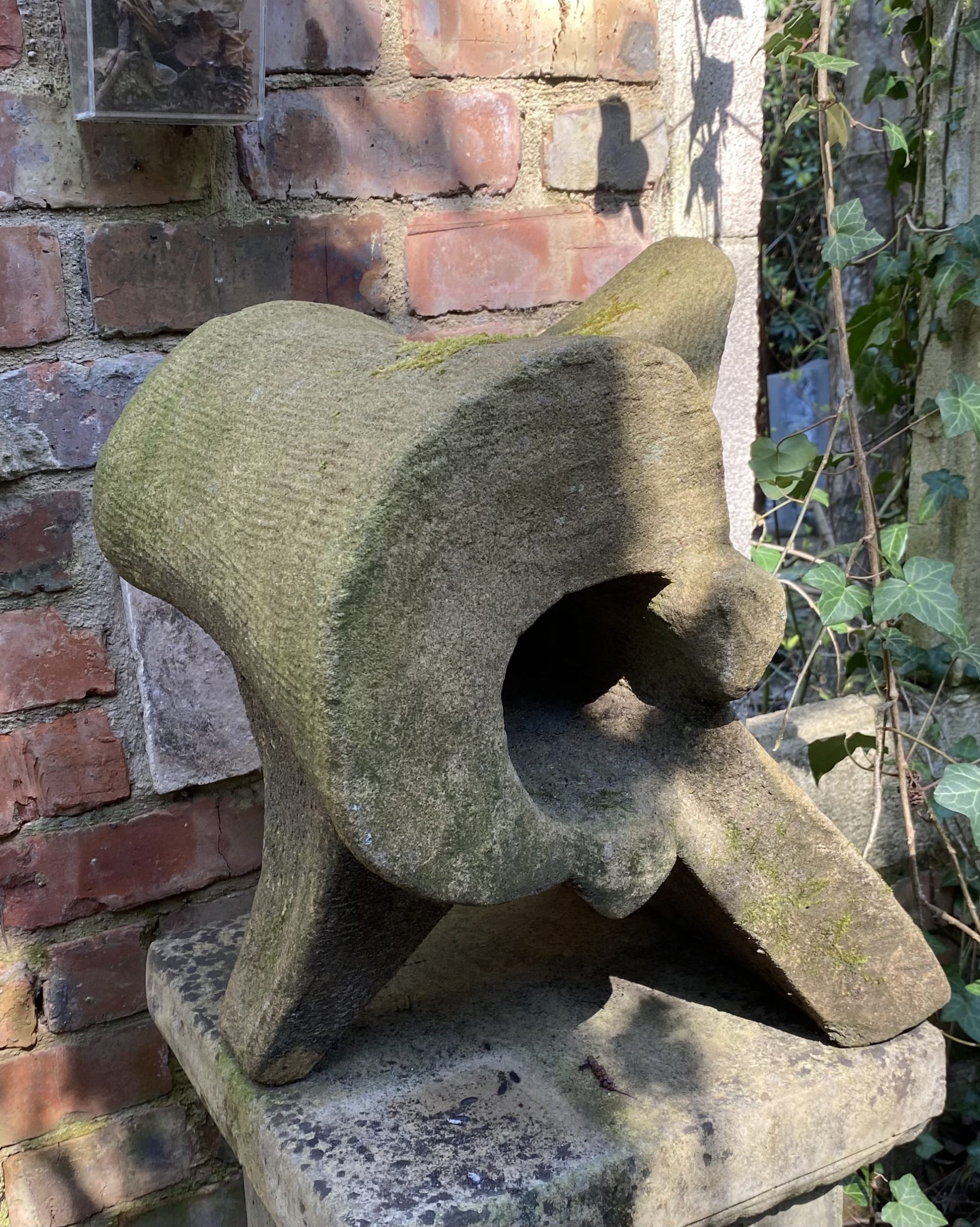 A expressionism stone sculpture of a piece of bone vertebrae.