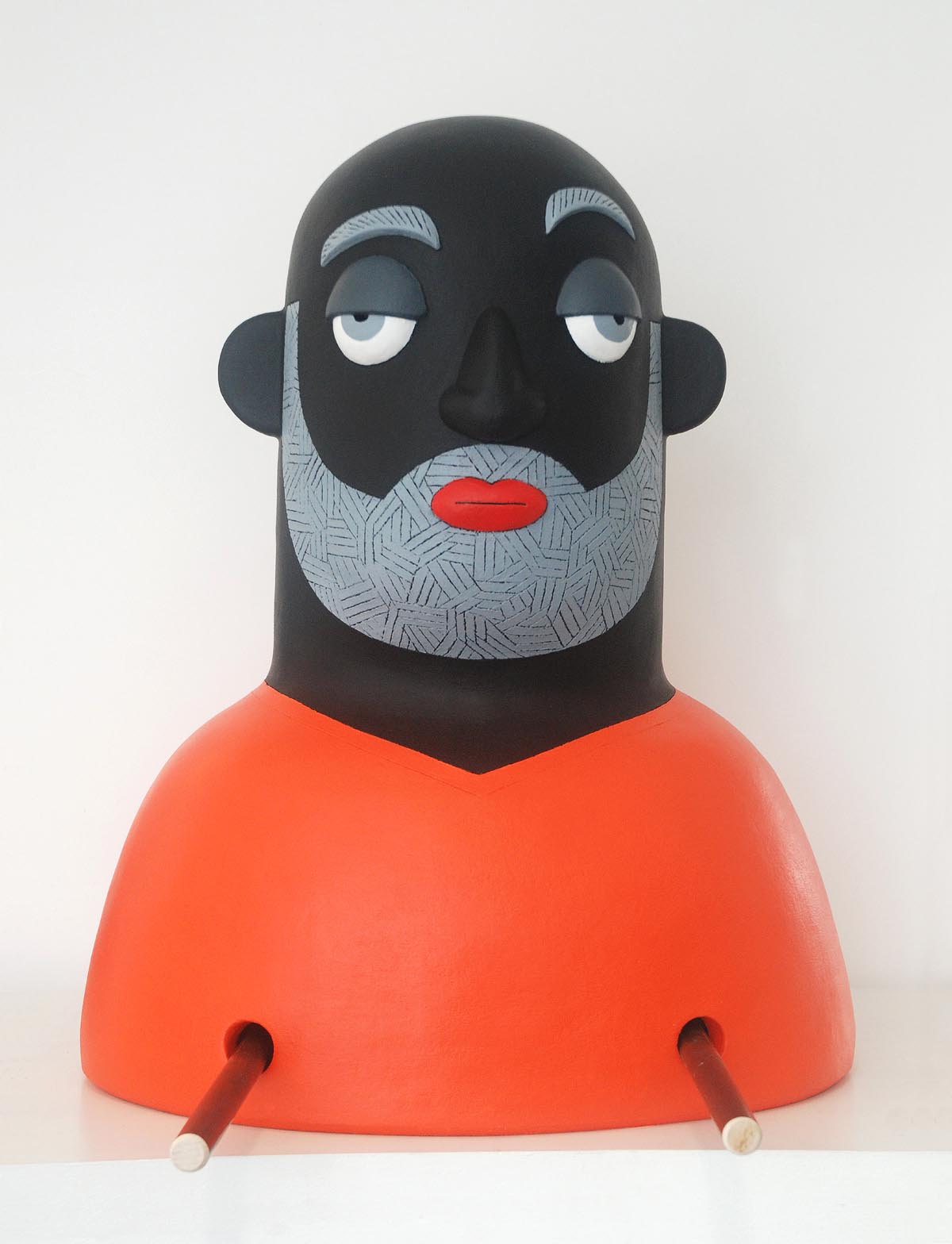 A figurative painted clay and metal sculpture of a man with two holes in his chest.