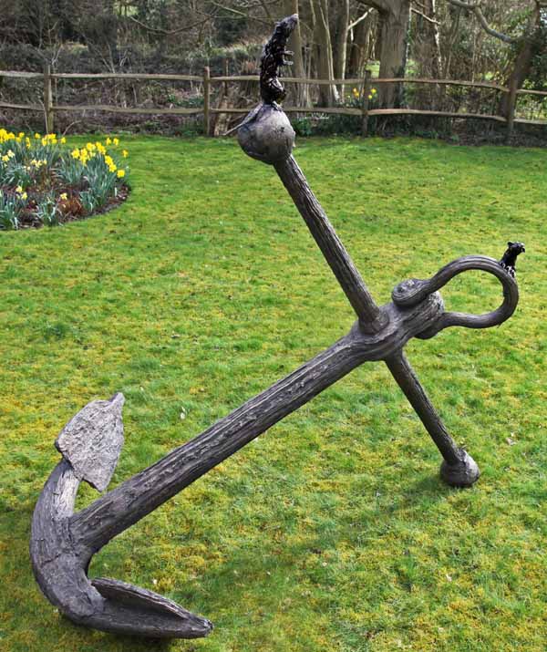 A realism bronze sculpture of a large anchor with a rat and mouse climbing on top of it.