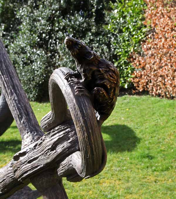 A realism bronze sculpture of a large anchor with a rat and mouse climbing on top of it.