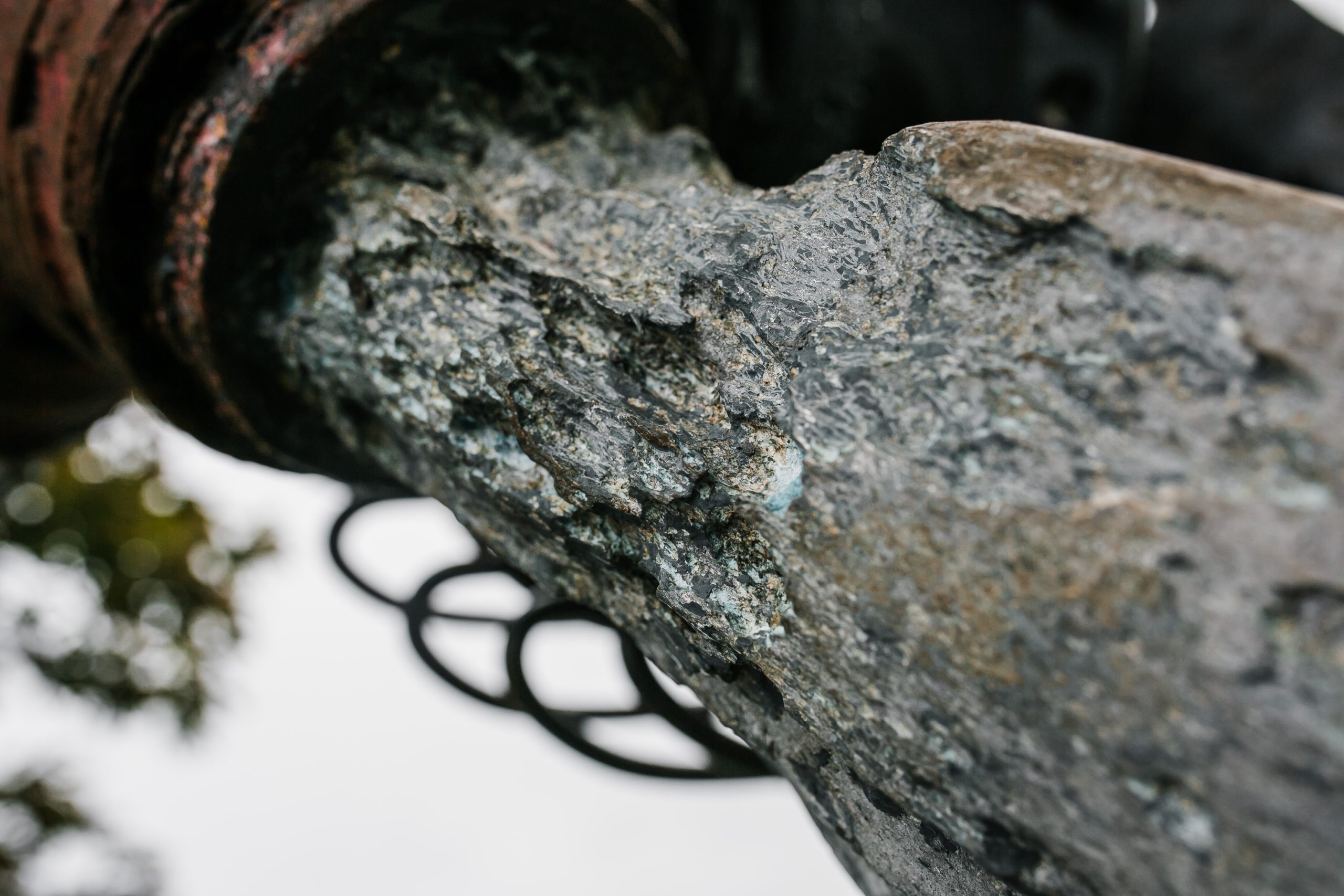 A architectural found object sculpture of a plane propeller mounted onto a metal frame.