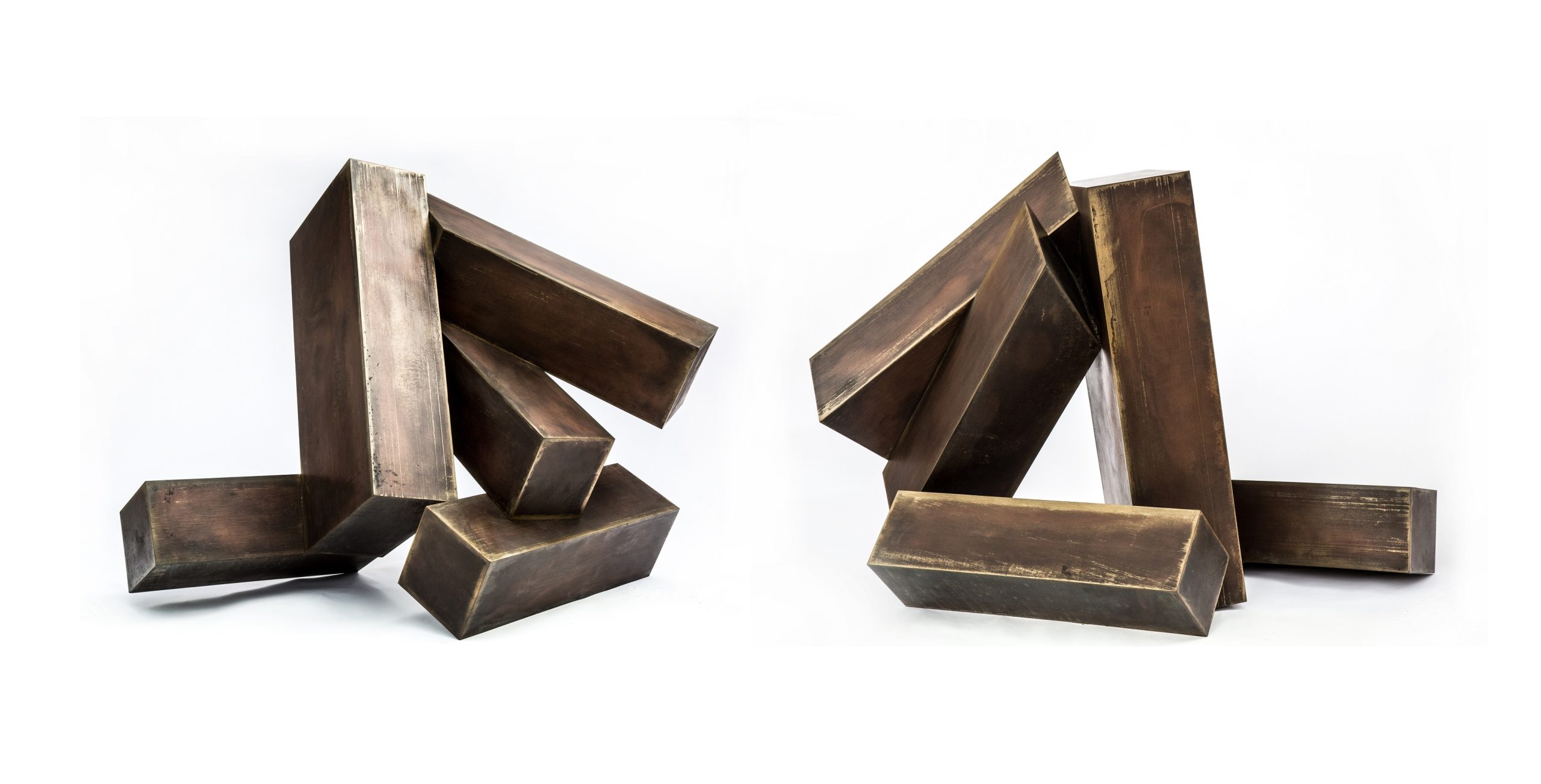 A modern bronze sculpture of two abstract shapes paired together.
