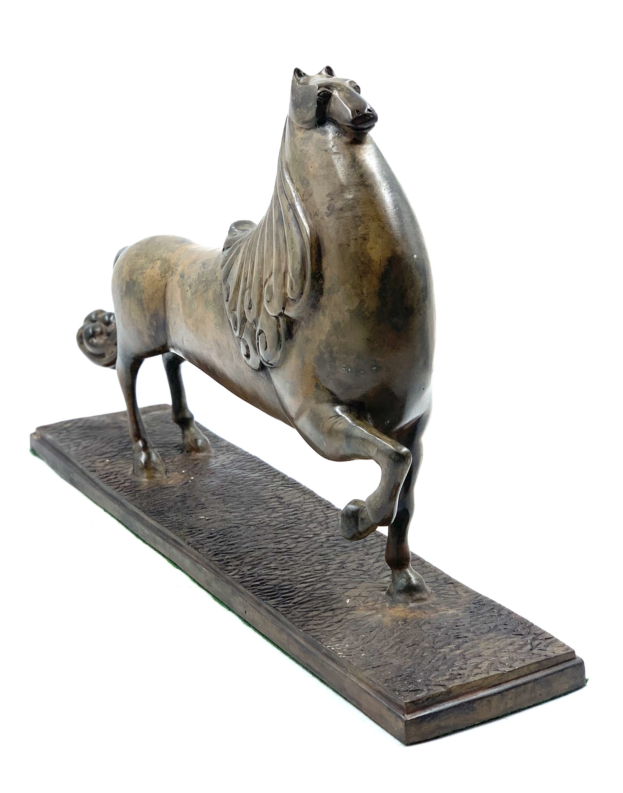 A bronze sculpture of an abstract horse.