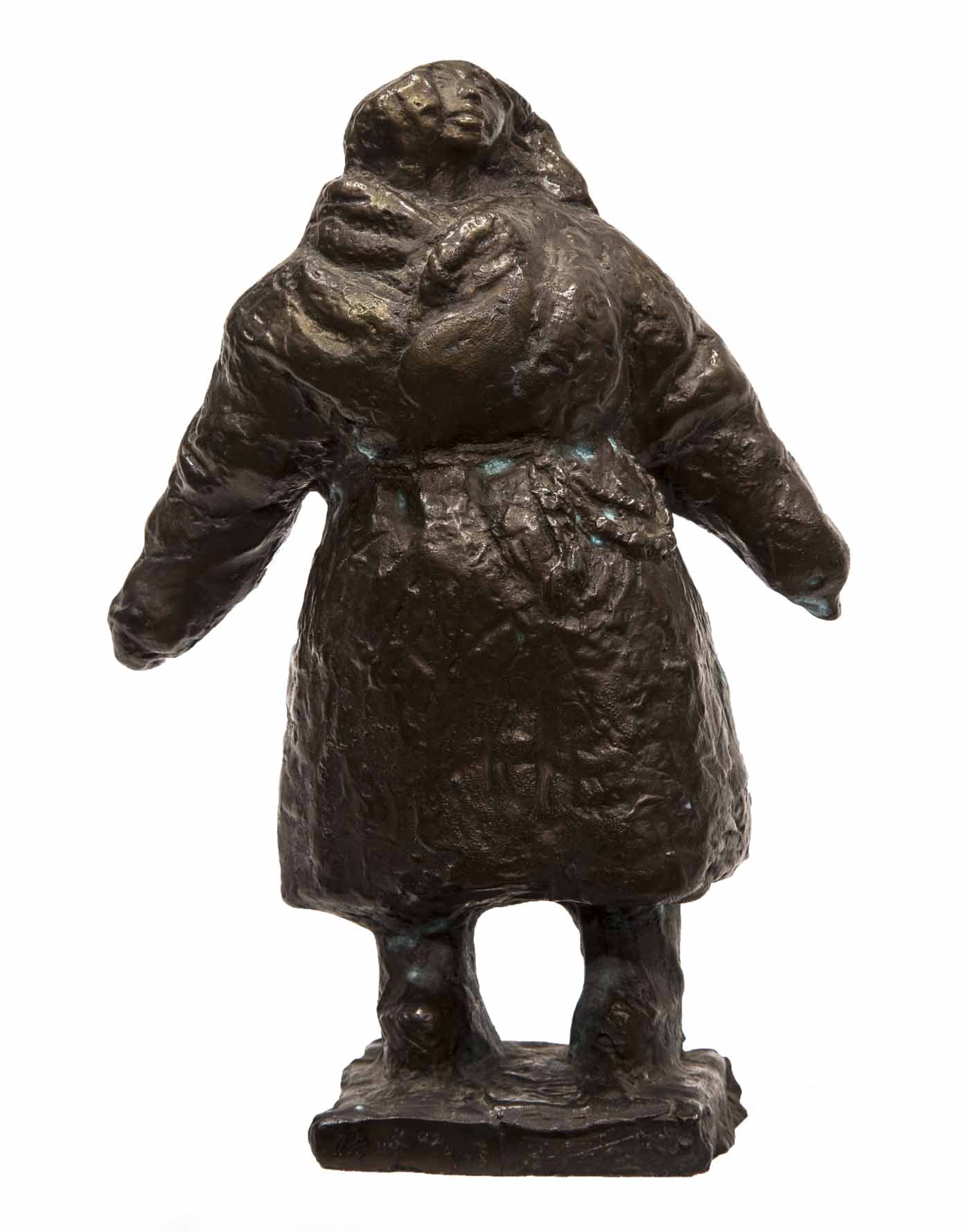 A figurative bronze sculpture of a woman in a thick coat standing with her head turned skywards.